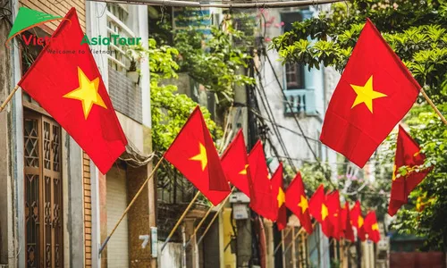 La gente cuelga banderas con motivo del día nacional de Vietnam